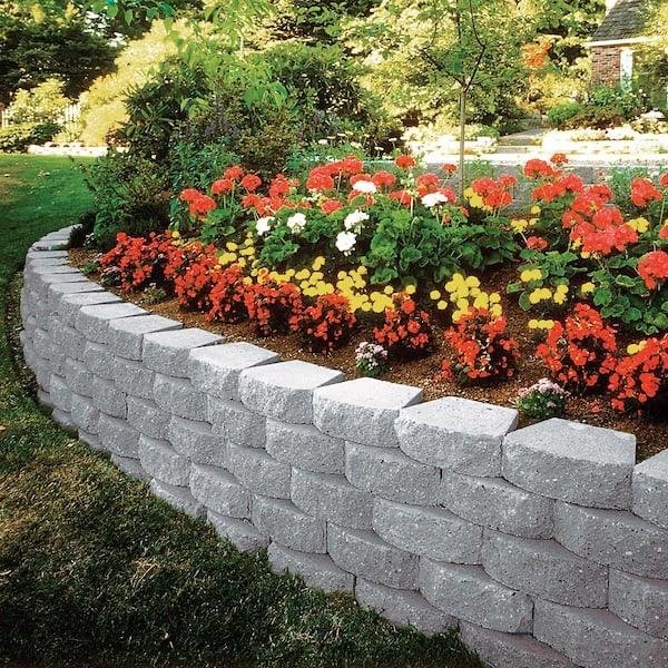 A charming stone retaining wall adorned with vibrant flowers, enhancing the beauty of a serene garden setting in Lakeland, FL